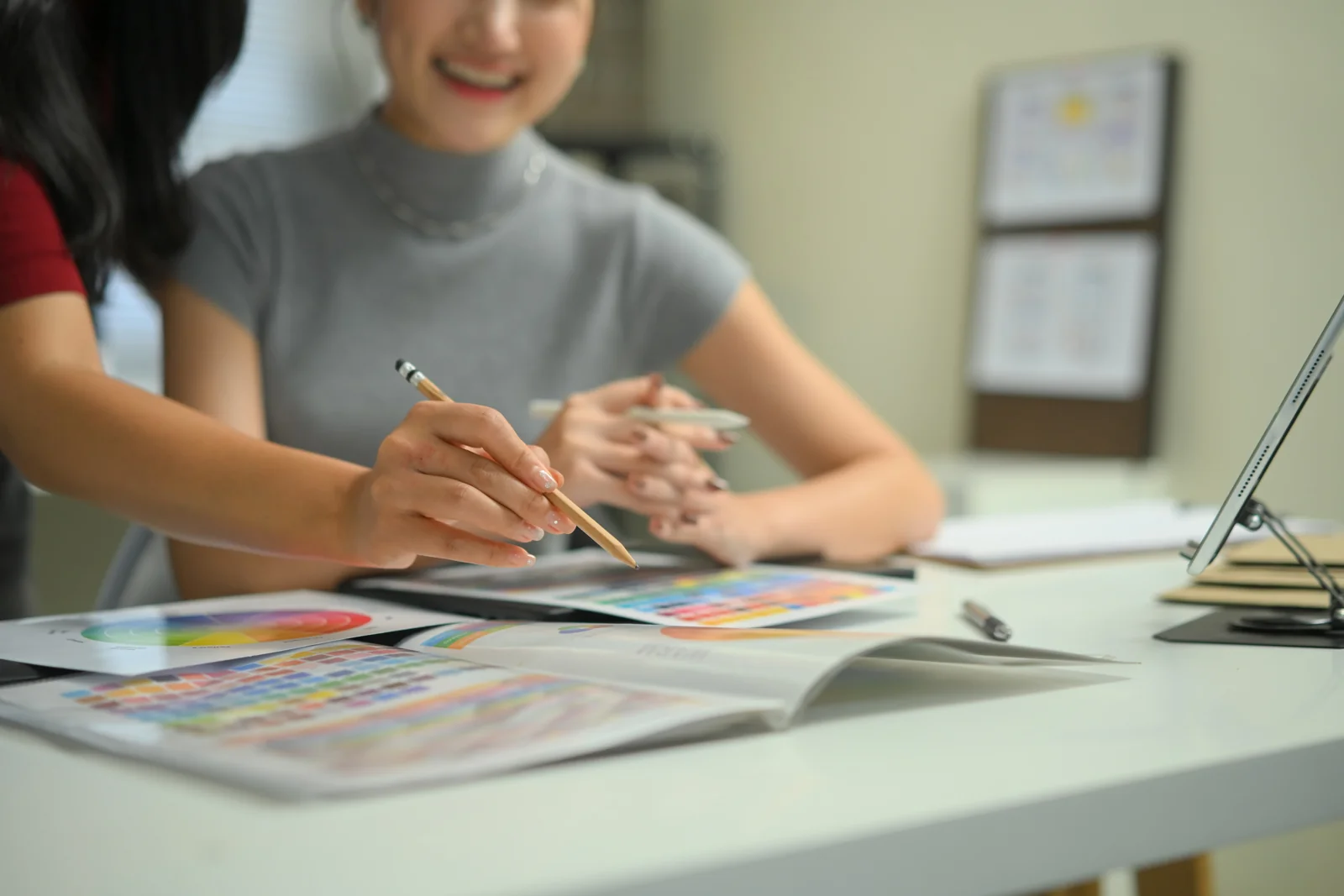Designers reviewing color palettes and printed materials together